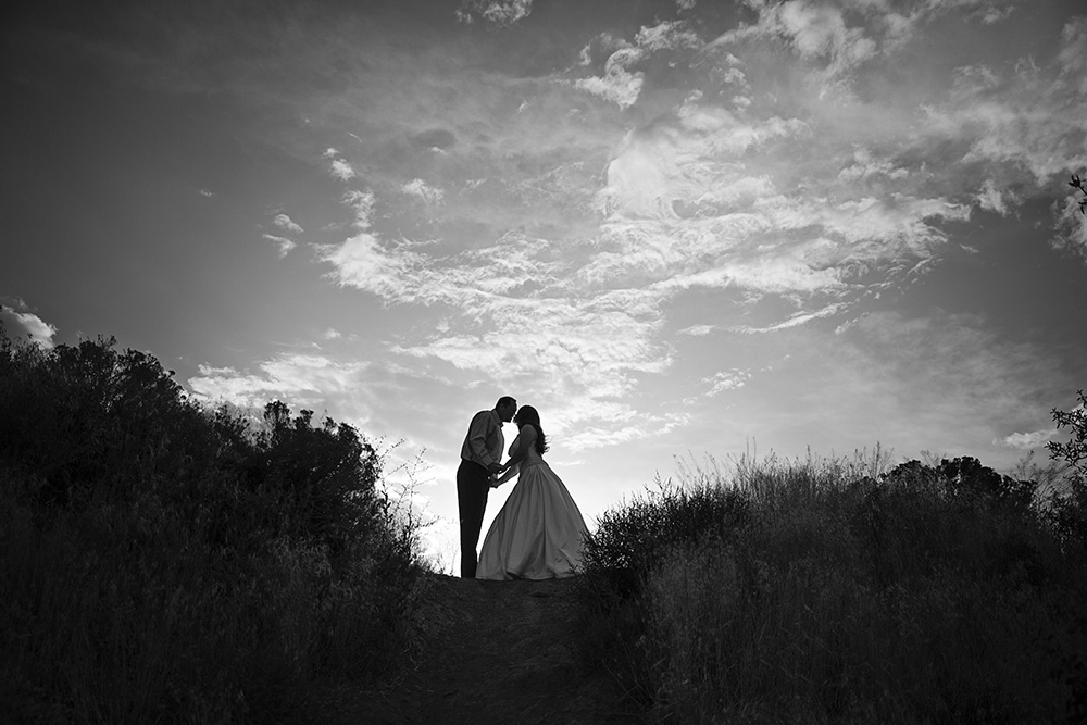 Black & White Anniversary Portrait of Wife in Wedding Dress Kissing Husband | Meet the Photographer Amanda Howse