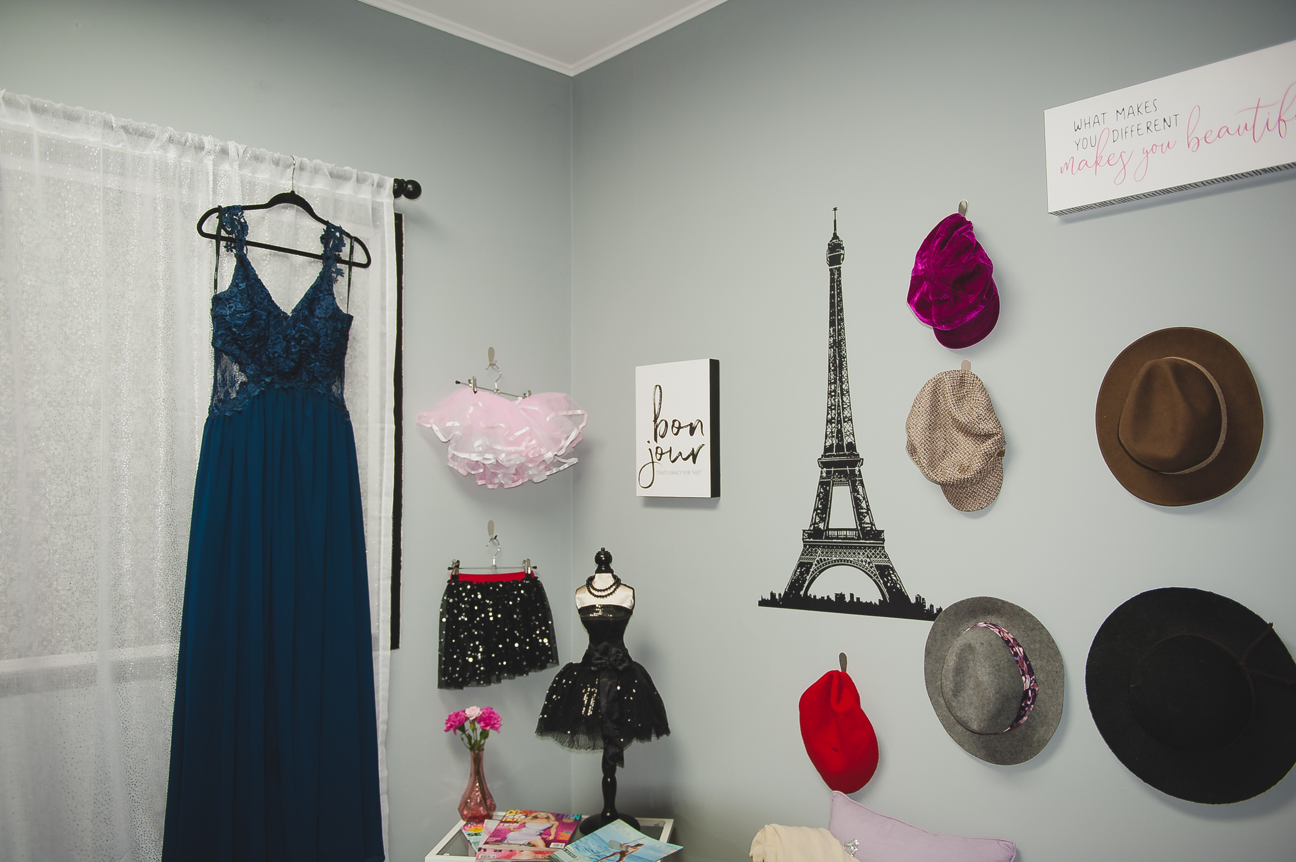 Travel Inspired Wall with Eiffel Tower, Hats and Accessories for Senior Portrait Sessions at Studio 253 in Tacoma