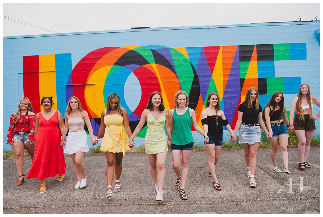 Rainbow themed senior portraits with bright LOVE mural in background and coordinated outfits | AHP Model Team photographed by Tacoma Senior Photographer Amanda Howse