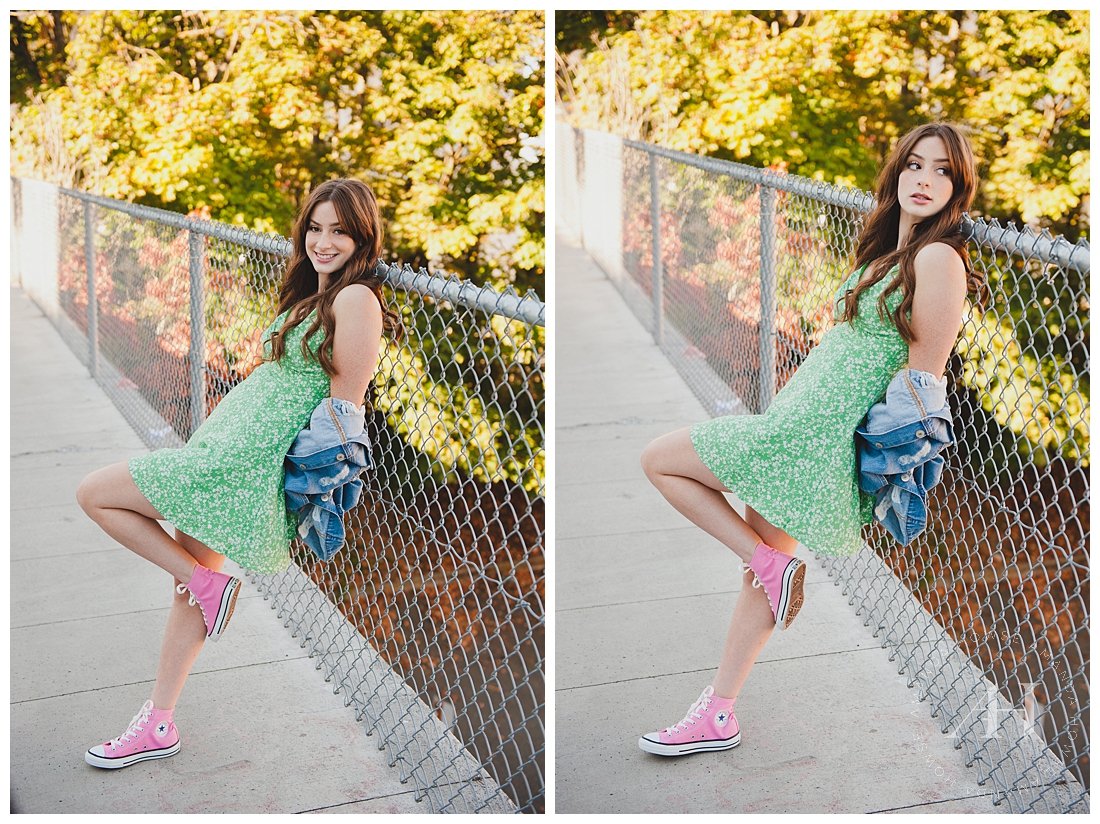 How to Style a Dress and Chuck Taylors | High School Senior Girl Poses by Metal Fence in Cute Green Dress and Hot Pink Converse | Photographed by the Best Tacoma Senior Portrait Photographer Amanda Howse